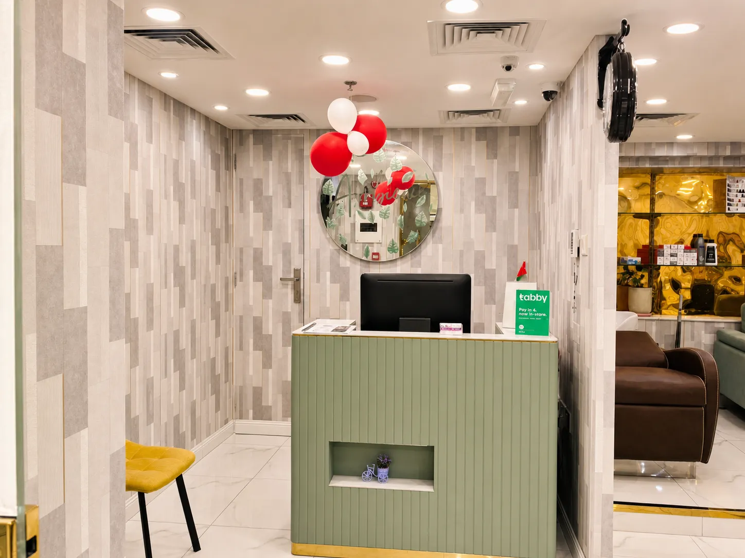 Warm wooden reception desk and lounge seating for men